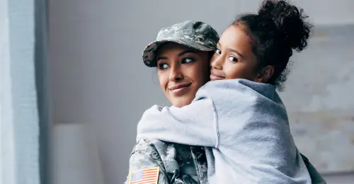 A woman in military uniform embraces a child, symbolizing love and support amidst a backdrop of service and sacrifice.